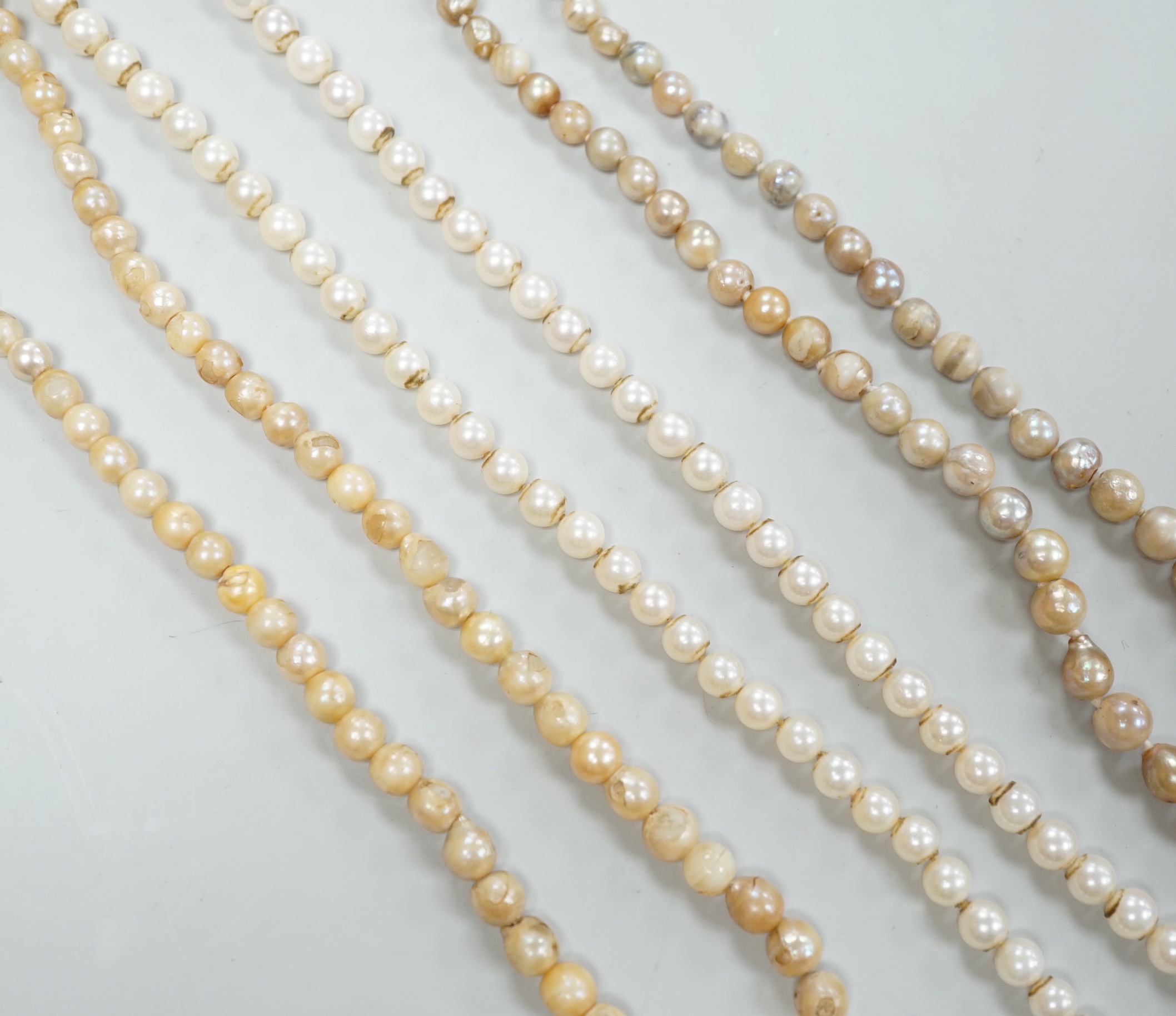 Three assorted single strand cultured pearl necklaces, longest 58cm.